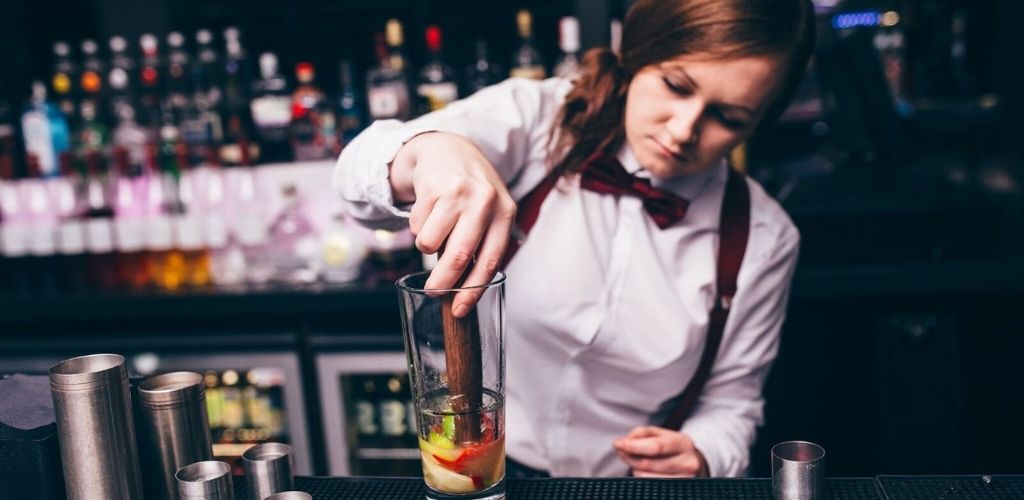 A cute Glasgow bartender mixing cocktails in
