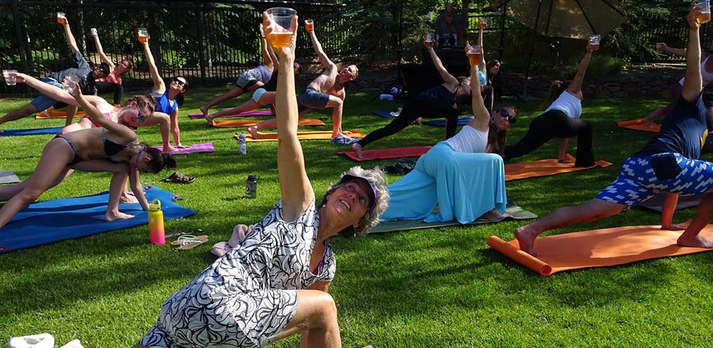 Practicing yoga in the outdoor courtyard of Zenergy