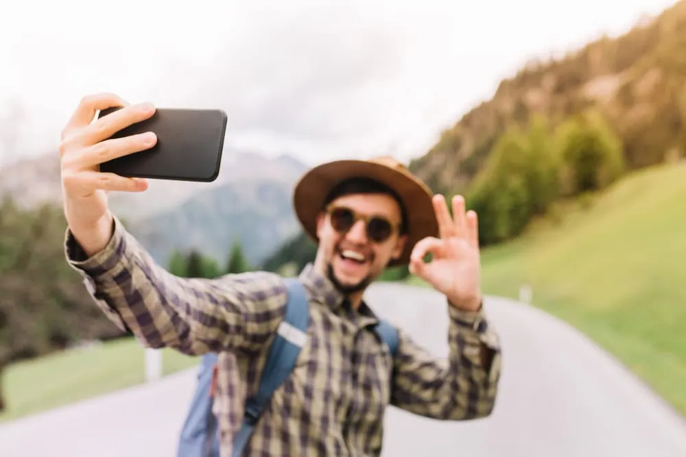 Man creating an appealing dating profile photo outdoors, key to getting responses on hookup apps