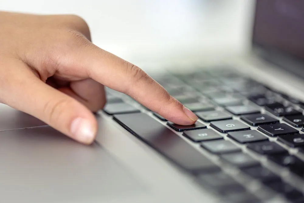 Close-up of a hand about to click a skip button on a digital interface