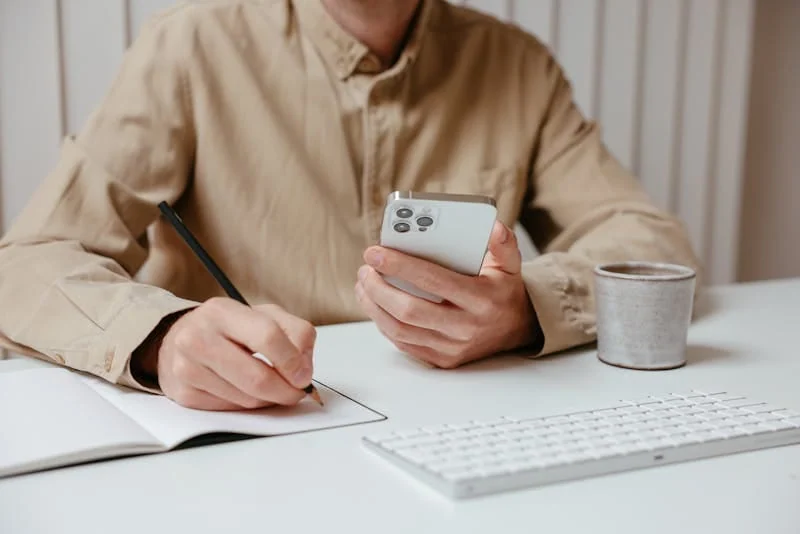 Notebook checklist with a dating plan beside a phone and coffee